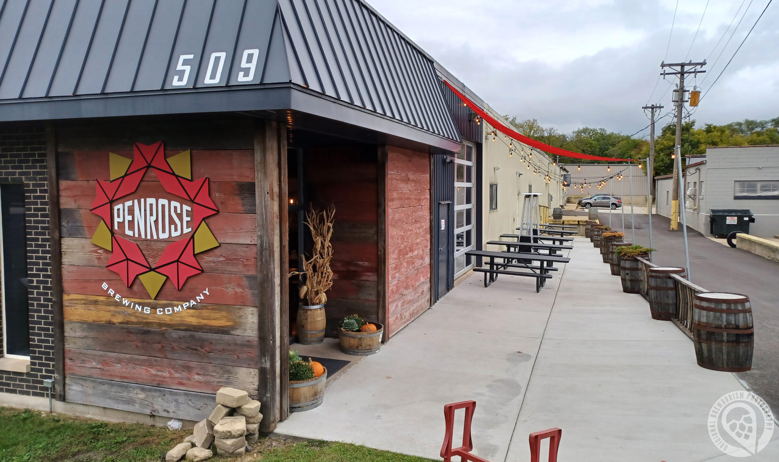 Front of the Penrose Brewing building with outdoor seating