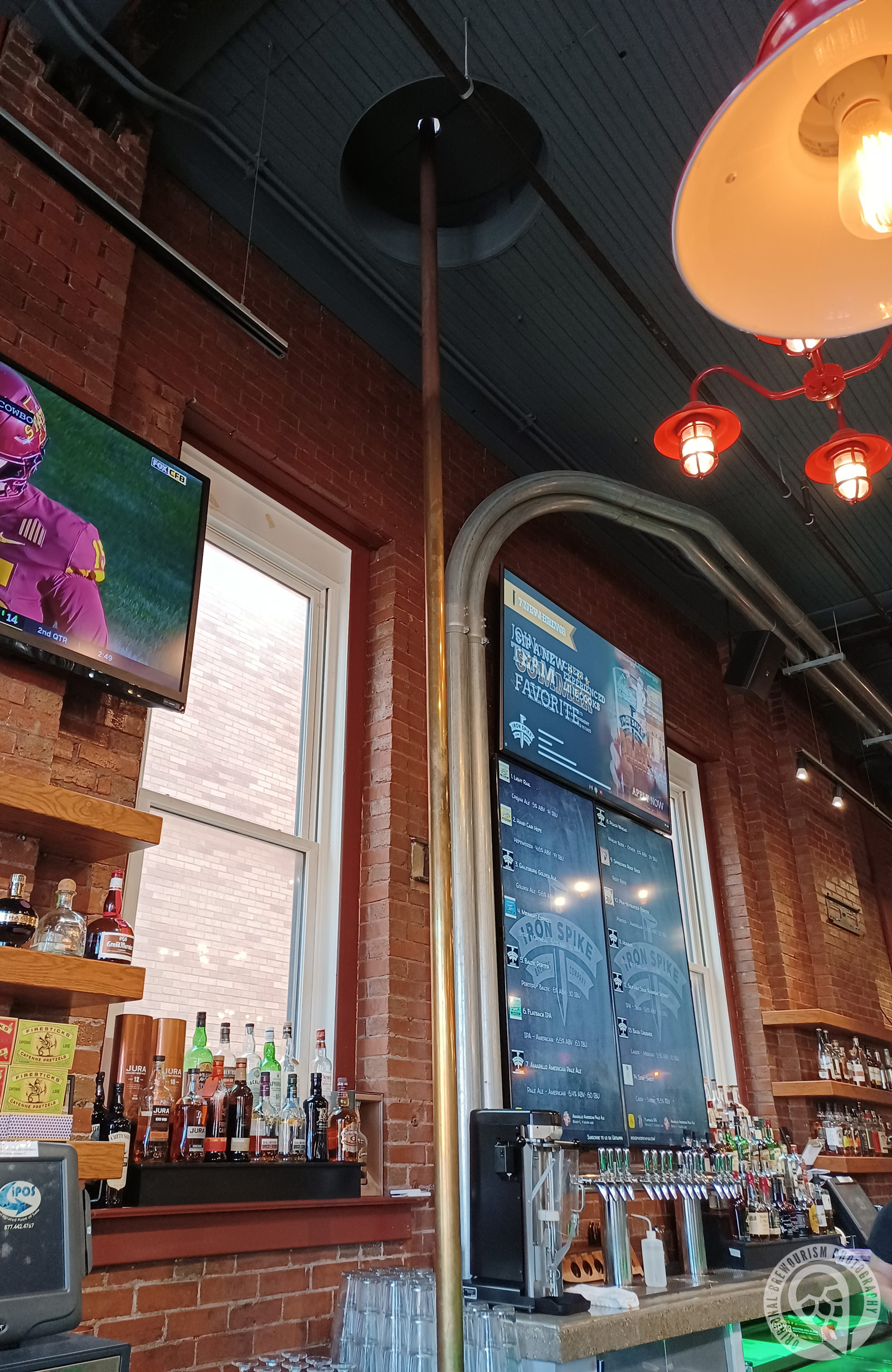 The fireman pole behind the car at Iron Spike Brewing