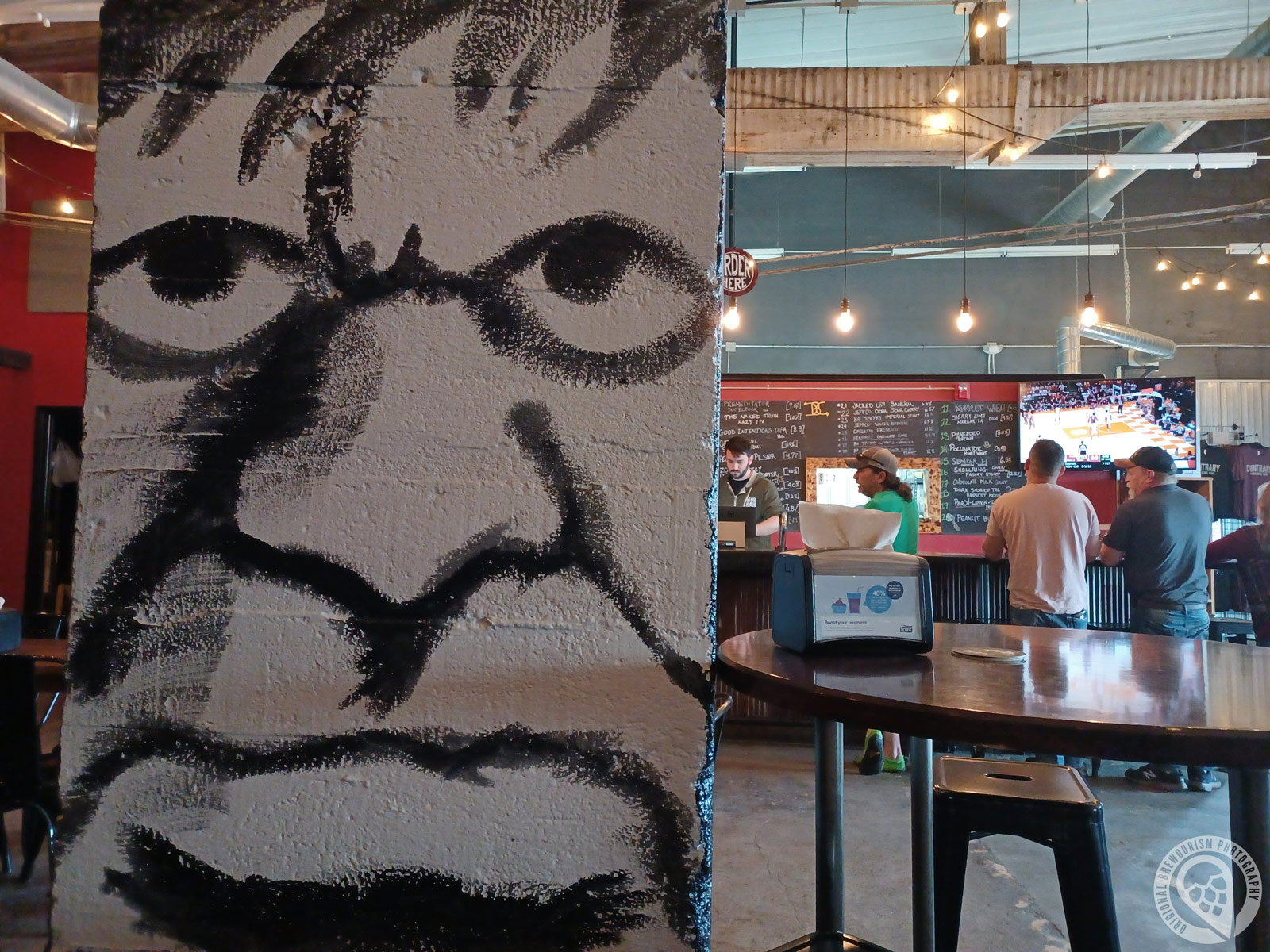 Wall art of face at Contrary Brewing