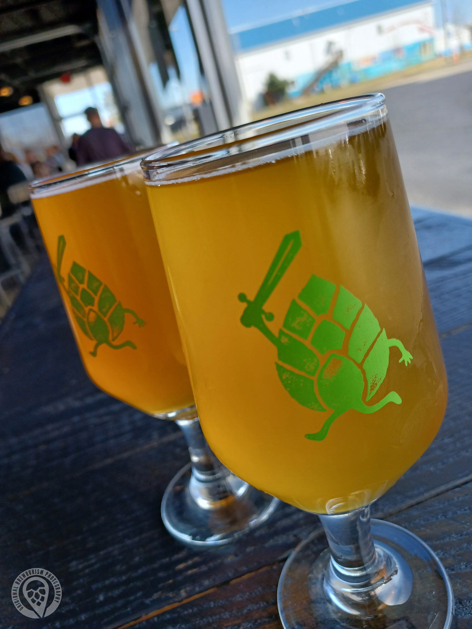 Two glasses of beer from Adventurous Brewing on a table